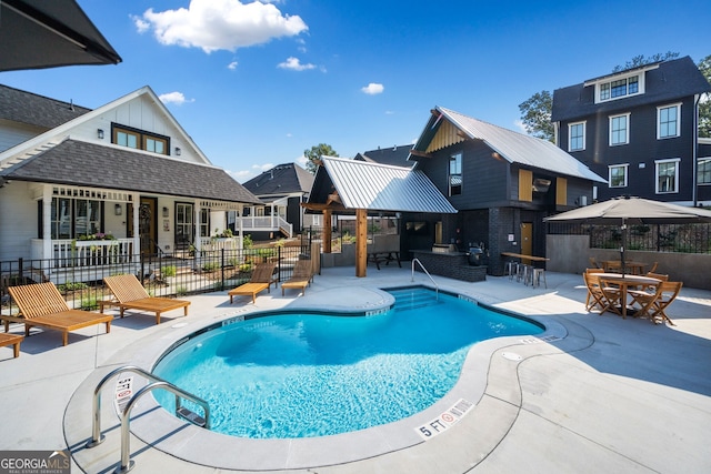 view of swimming pool featuring a patio area