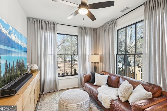 living area with ceiling fan