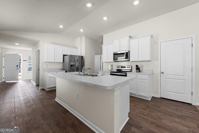 kitchen featuring white cabinetry, stainless steel appliances, sink, and a center island with sink