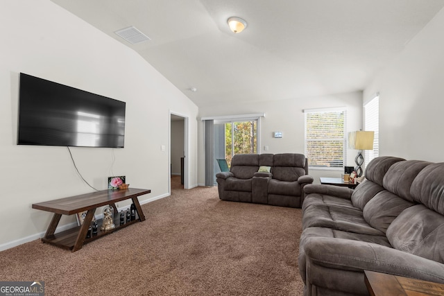 carpeted living room with lofted ceiling