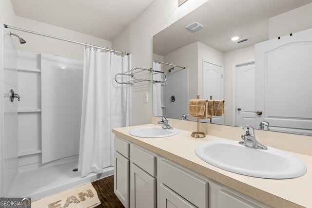 bathroom with vanity, hardwood / wood-style floors, and a shower with shower curtain