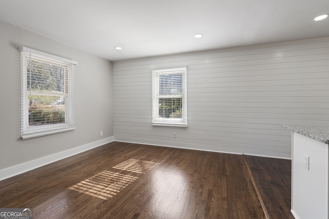 unfurnished room with dark hardwood / wood-style flooring