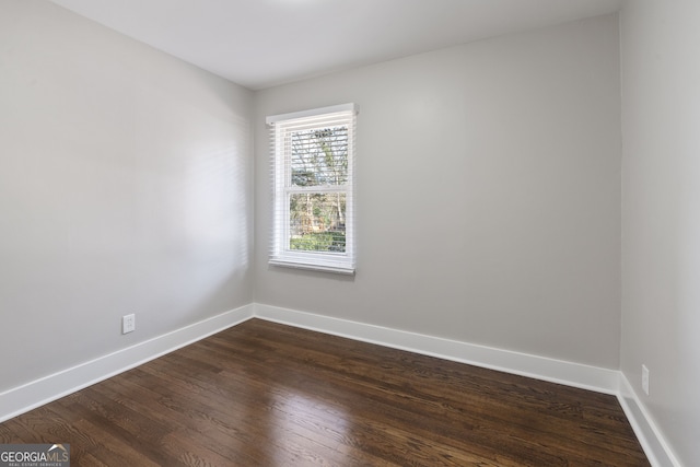 spare room with dark hardwood / wood-style flooring