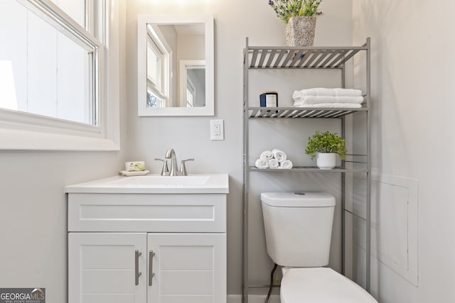 bathroom featuring vanity and toilet