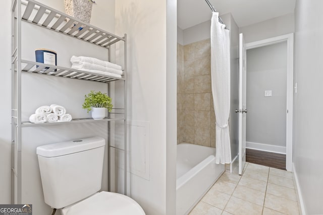 bathroom featuring shower / bath combo, tile patterned floors, and toilet