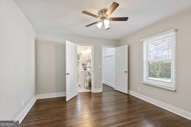 unfurnished bedroom with dark hardwood / wood-style flooring and ceiling fan