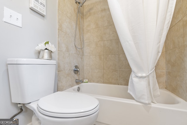 bathroom featuring toilet and shower / bath combo with shower curtain