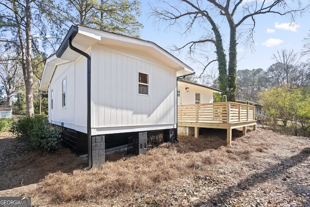 view of property exterior featuring a wooden deck