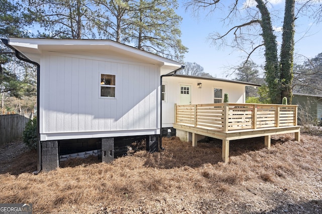 back of house with a deck