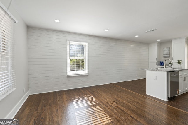 kitchen featuring white cabinetry, light stone counters, dark hardwood / wood-style flooring, and dishwasher