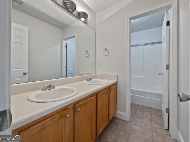 bathroom with vanity, tile patterned floors, and a textured ceiling