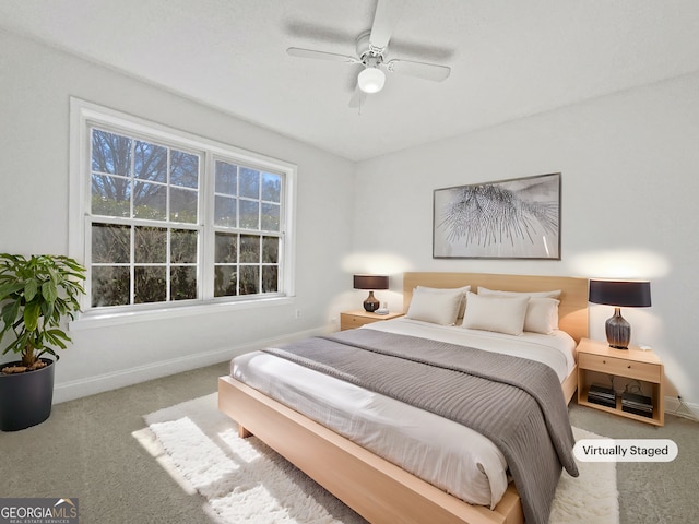 bedroom with ceiling fan and carpet floors