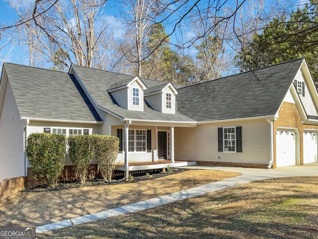 cape cod house with a porch and a front yard