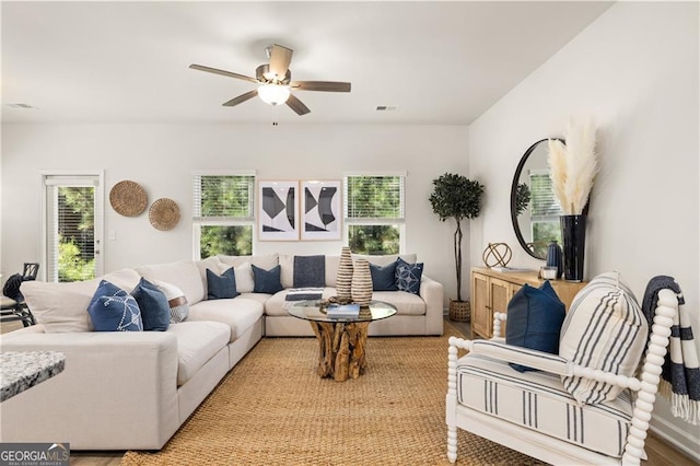 living room featuring ceiling fan and plenty of natural light