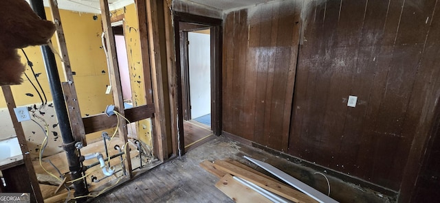 hall featuring wood walls