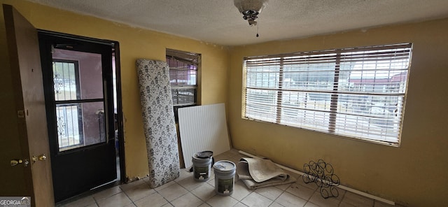 tiled entrance foyer with a textured ceiling