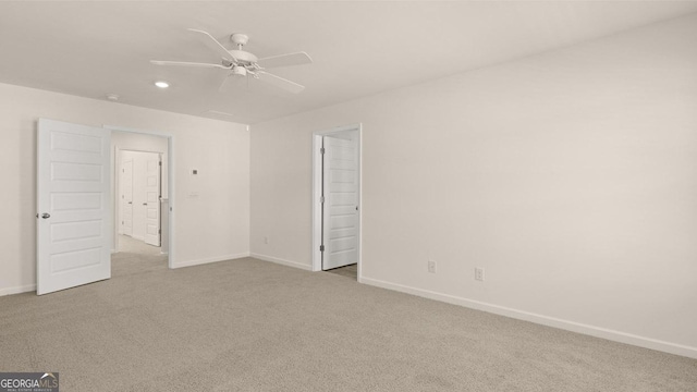 unfurnished room with ceiling fan and light carpet