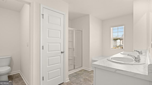 bathroom with vanity, toilet, and a shower with shower door