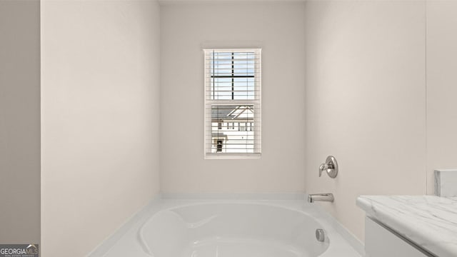 bathroom featuring a wealth of natural light and a washtub