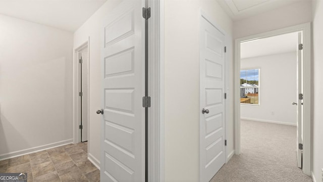 hallway with light colored carpet