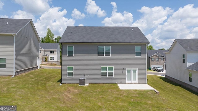 back of property with a patio, central AC, and a lawn