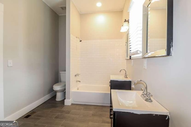 full bathroom featuring tiled shower / bath combo, vanity, ornamental molding, and toilet