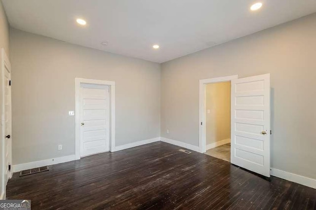 spare room with dark wood-type flooring