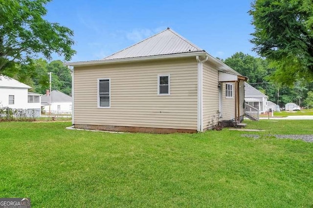 view of side of property with a lawn