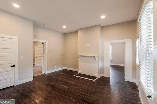 unfurnished room with dark hardwood / wood-style flooring