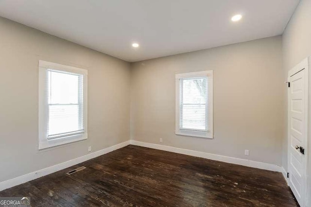 spare room with dark hardwood / wood-style flooring