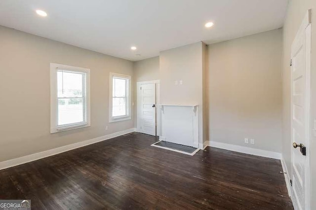 unfurnished room with dark hardwood / wood-style floors