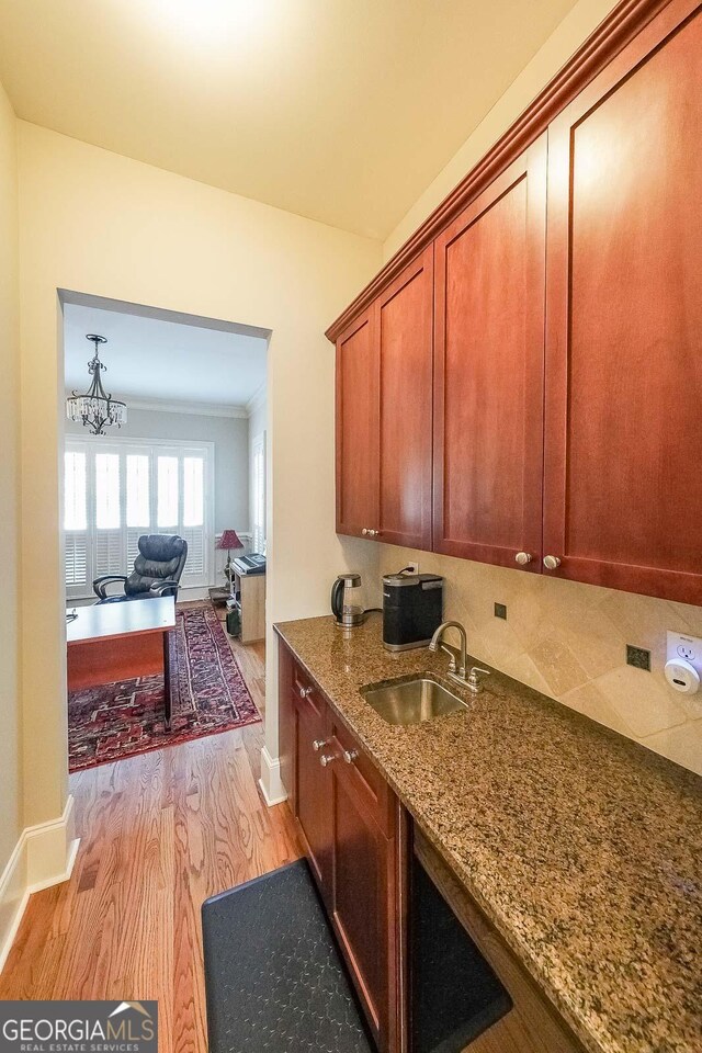 bathroom with a relaxing tiled tub, ornamental molding, tile patterned flooring, and vanity