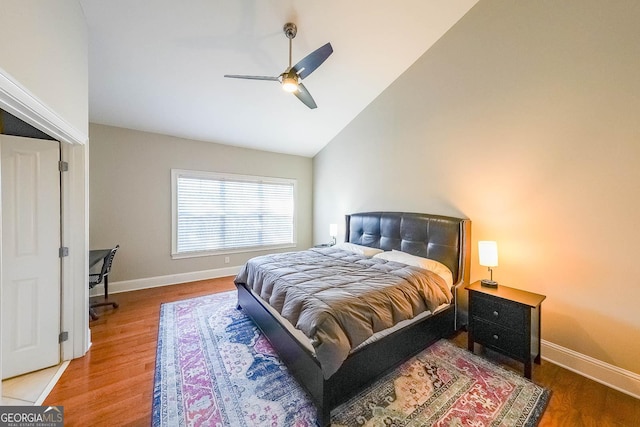 bedroom featuring high vaulted ceiling, wood finished floors, a ceiling fan, and baseboards