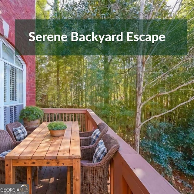 view of wooden balcony featuring outdoor dining area and a wooden deck