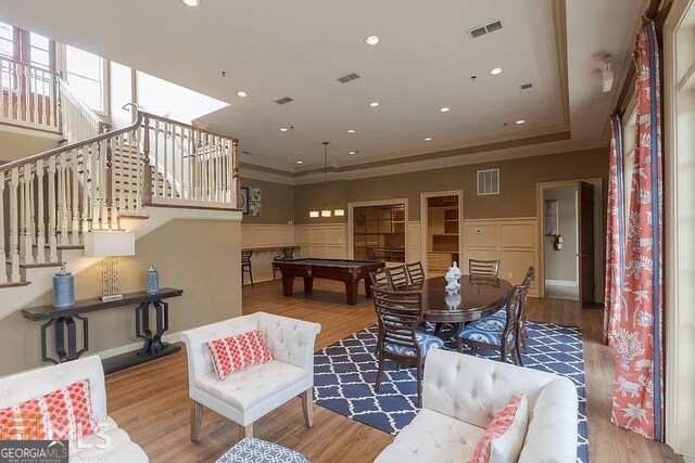 living room with crown molding and light hardwood / wood-style flooring