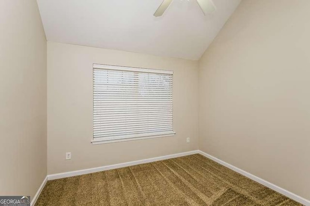 carpeted empty room featuring vaulted ceiling and ceiling fan