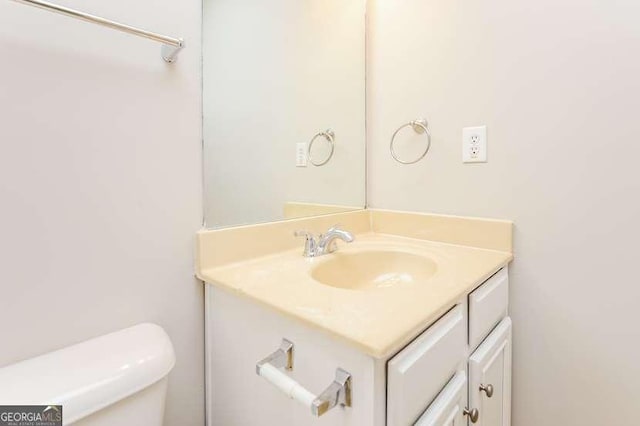 bathroom featuring vanity and toilet