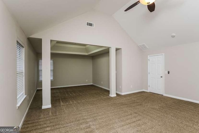 interior space with ceiling fan, high vaulted ceiling, and dark colored carpet