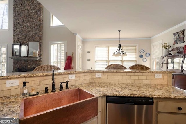 kitchen featuring crown molding, stainless steel dishwasher, decorative light fixtures, and sink