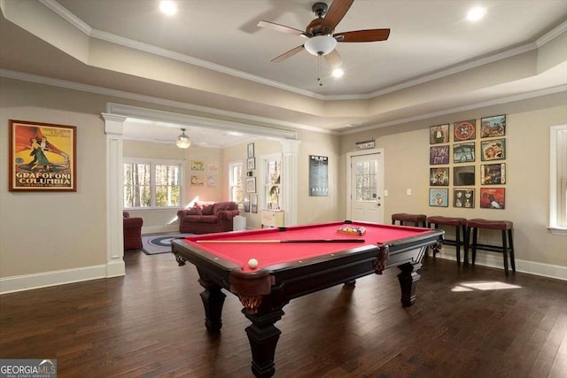 playroom featuring crown molding, dark wood-type flooring, a raised ceiling, and ceiling fan