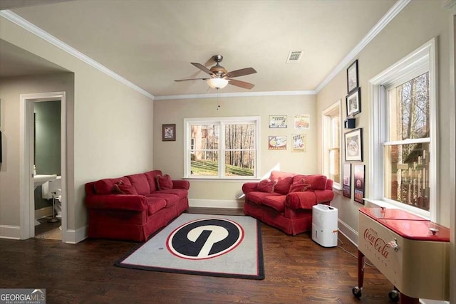 living room with crown molding, dark wood-type flooring, and ceiling fan