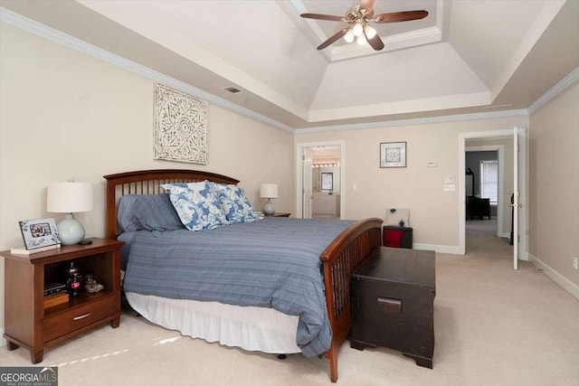 carpeted bedroom with a raised ceiling, ornamental molding, and ceiling fan