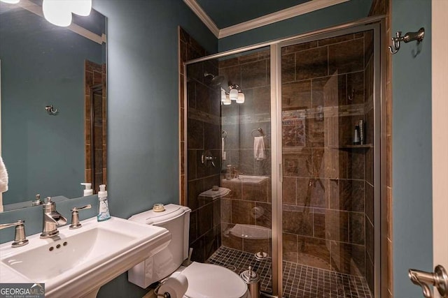 bathroom featuring sink, ornamental molding, a shower with door, and toilet