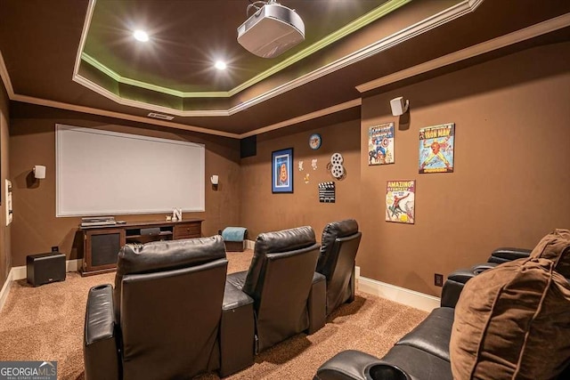 cinema room with a raised ceiling, crown molding, and carpet floors