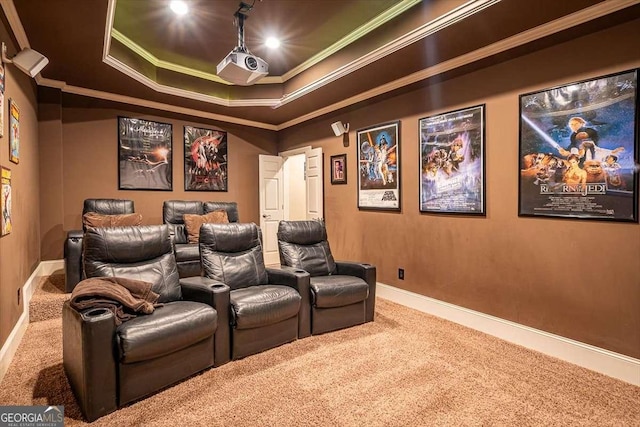 carpeted cinema featuring a raised ceiling and crown molding