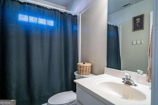 bathroom featuring vanity and toilet