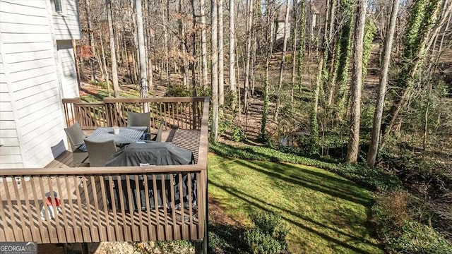 wooden deck featuring a lawn