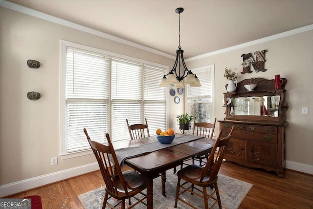 dining space featuring crown molding and dark hardwood / wood-style floors