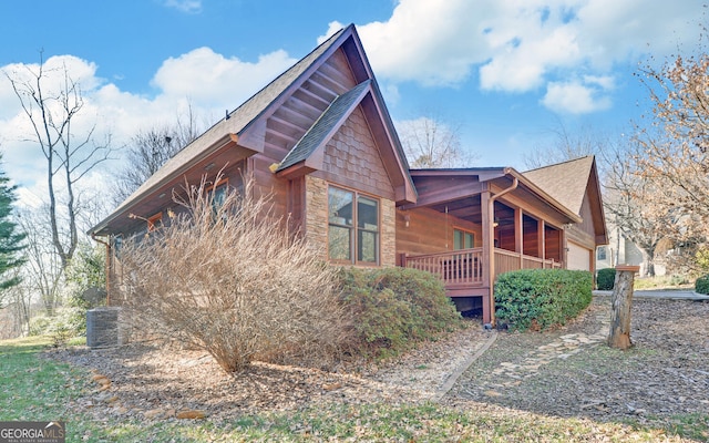 view of home's exterior featuring a garage and covered porch