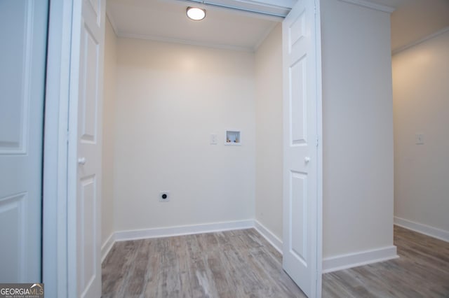 washroom with crown molding, electric dryer hookup, washer hookup, and light hardwood / wood-style flooring